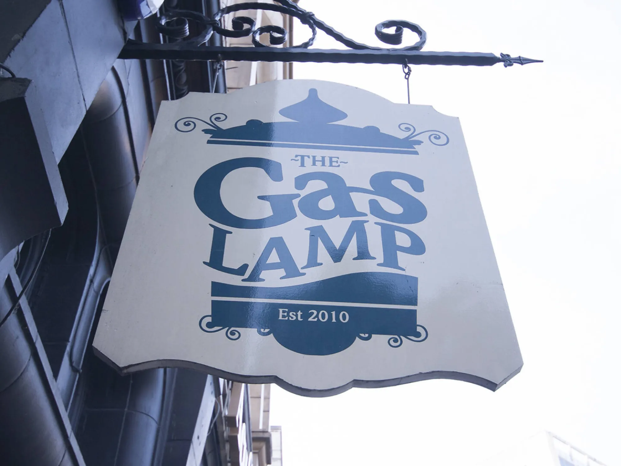 The Gas Lamp's hanging sign on the stone front of the building on Bridge Street, a craft beer bar in Manchester